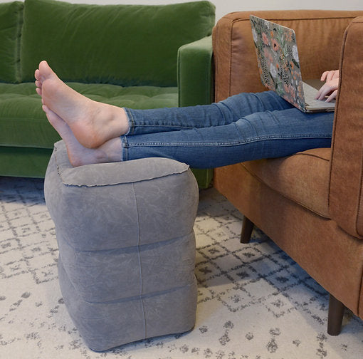 Inflatable top airplane footrest